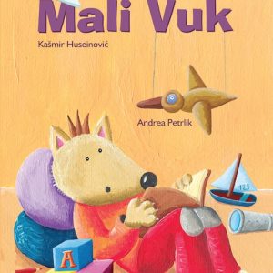 Mali Vuk sjedi u naslonjači i čita knjigu