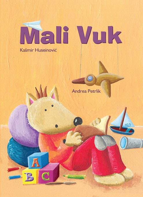Mali Vuk sjedi u naslonjači i čita knjigu